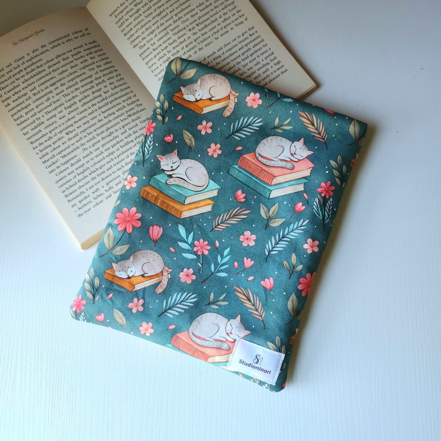 Cat Sleeping on Book Sleeve